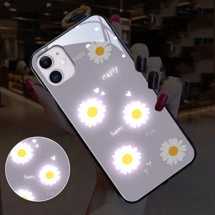 White TPU iPhone case with a painted purple daisy and letter design, showcasing its voice-activated luminous feature.