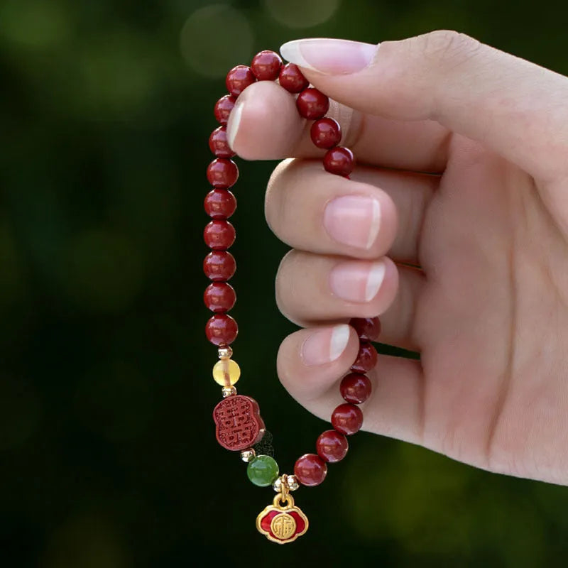 Happy Eyebrow Bracelet made of cinnabar with Emperor Sandstone beads and fu character charm.