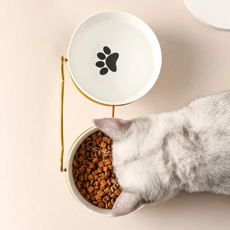 White ceramic cat bowl with decorative iron frame in cat footprints or fishbone design