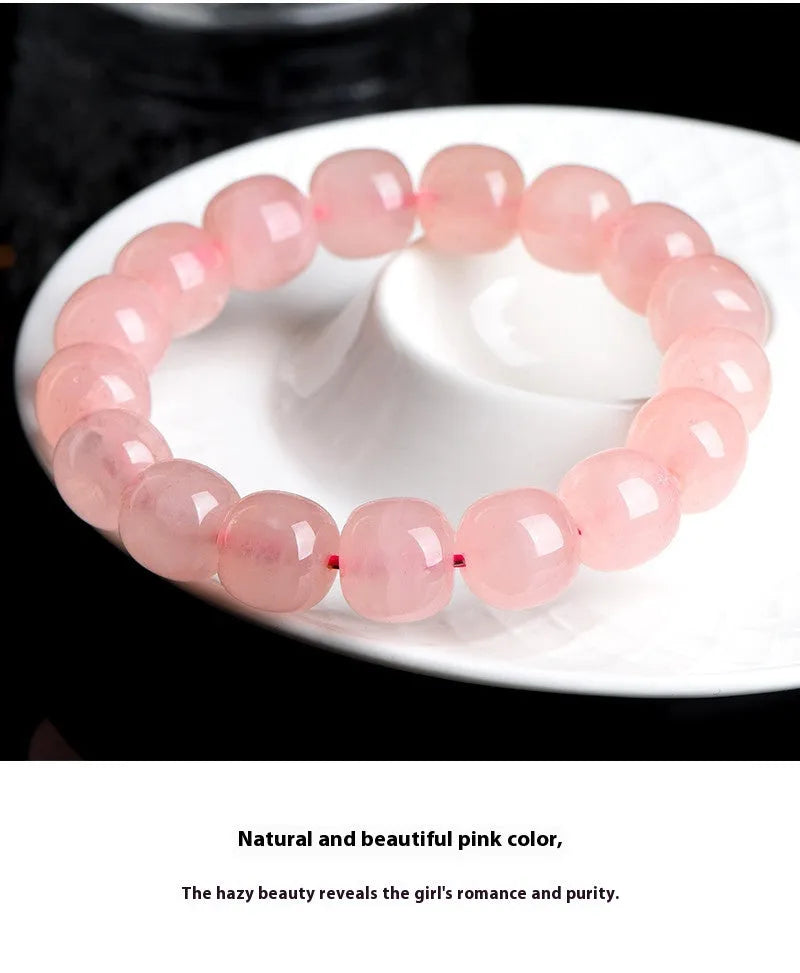Pink crystal barrel bead bracelet with geometric design and polished finish