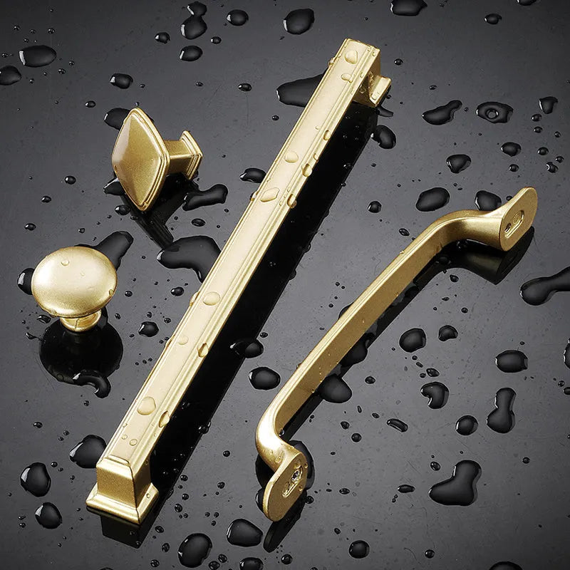 Gold aluminium alloy single-hole cabinet handle with T-shape design.