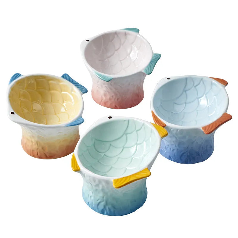 Fish-shaped ceramic cat bowls with elevated design and 15-degree tilt angle in blue, green, pink or yellow