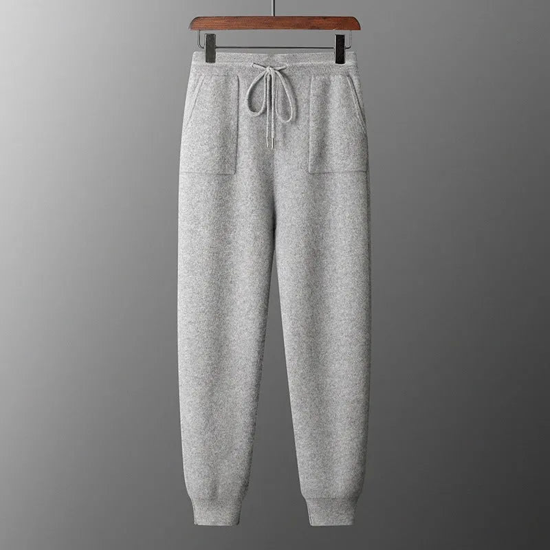 Men's light gray cashmere hooded sweatshirt and matching track pants laid flat.
