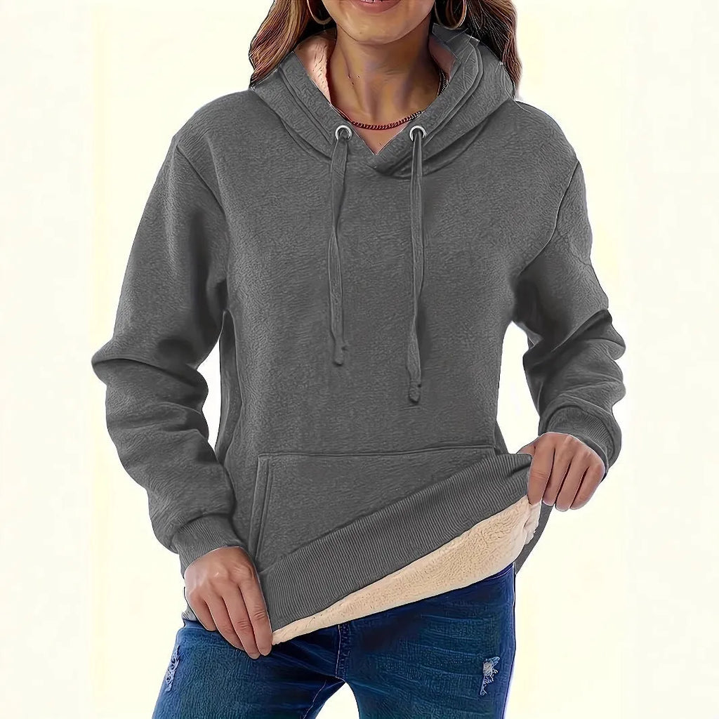 Women's loose-fit grey hooded sweater with a front pocket and a textured 3D pattern.