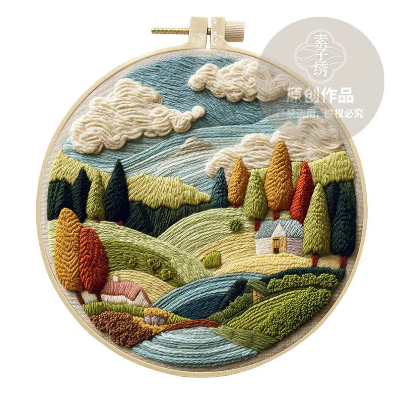 Embroidery DIY landscape kit with cotton fabric, bamboo frame, threads, and needles for handmade cloth art.