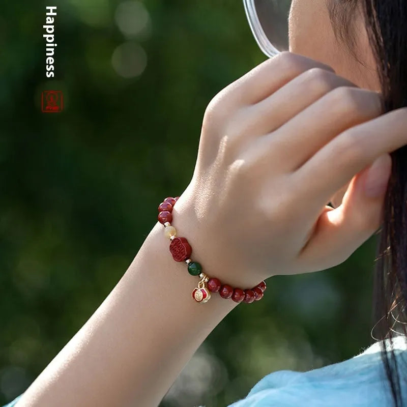 Happy Eyebrow Bracelet made of cinnabar with Emperor Sandstone beads and fu character charm.