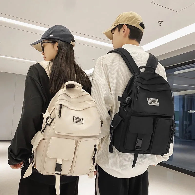 Black and white student nylon backpack with laptop compartment and outer pockets.