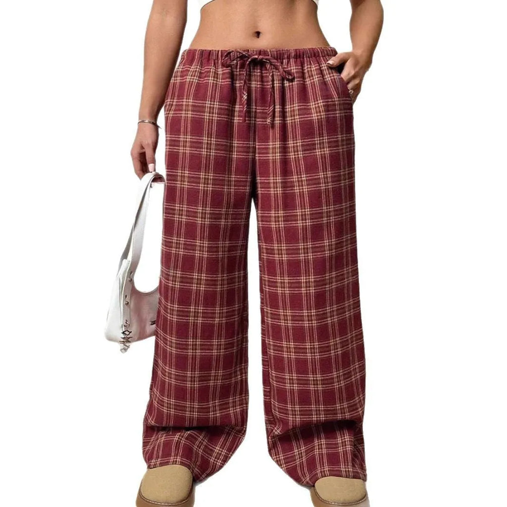 Women's red plaid casual trousers with drawstring waist and side pockets laid flat
