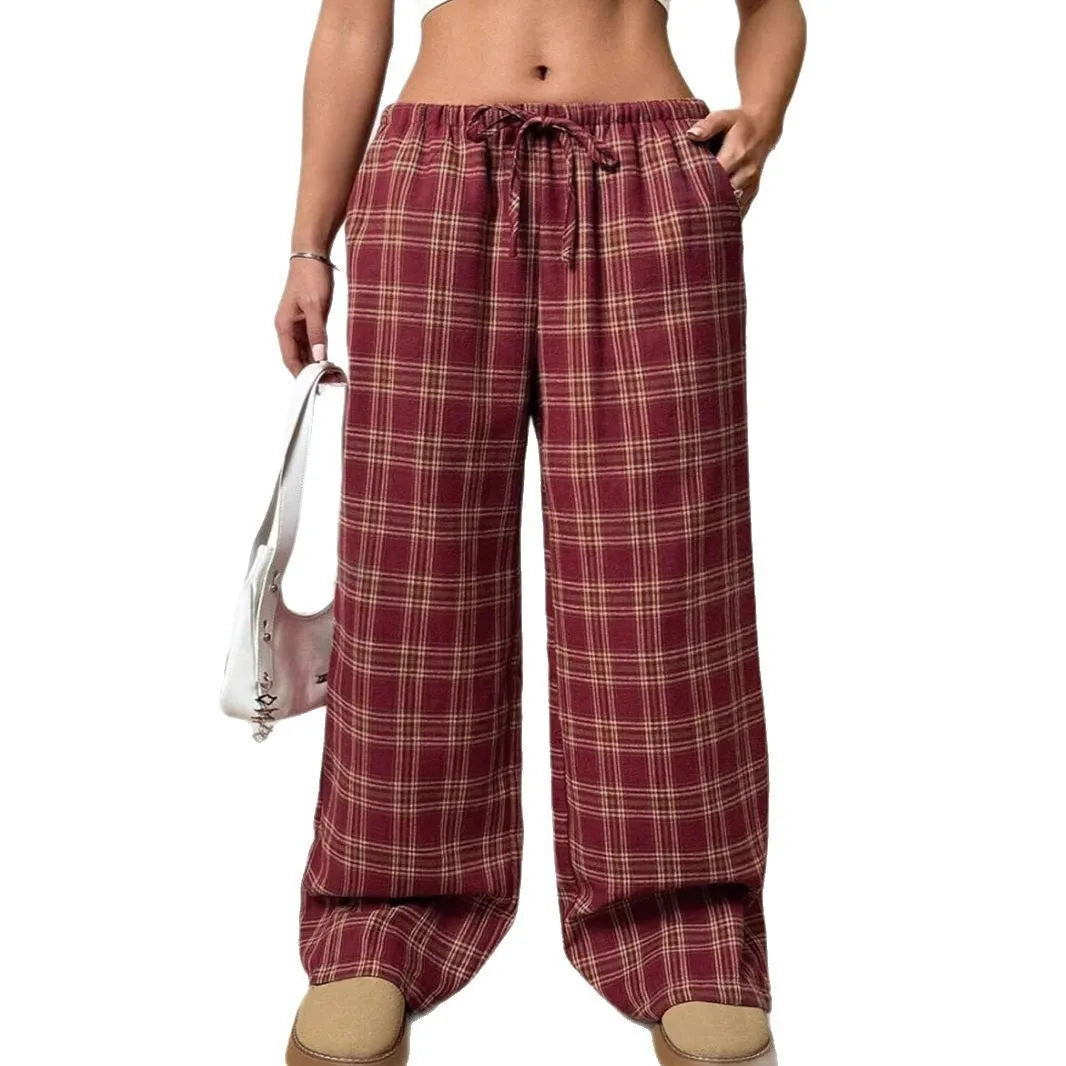 Women's red plaid casual trousers with drawstring waist and side pockets laid flat