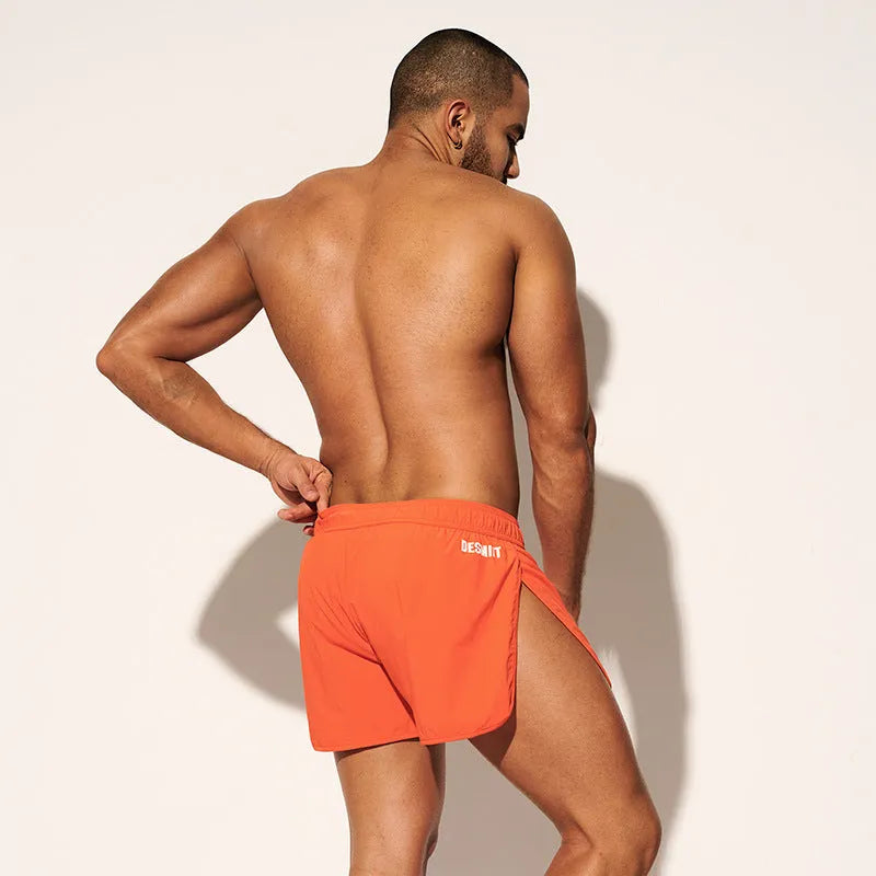 Men's loose fit elastic beach surfing shorts in orange, green, or black colours