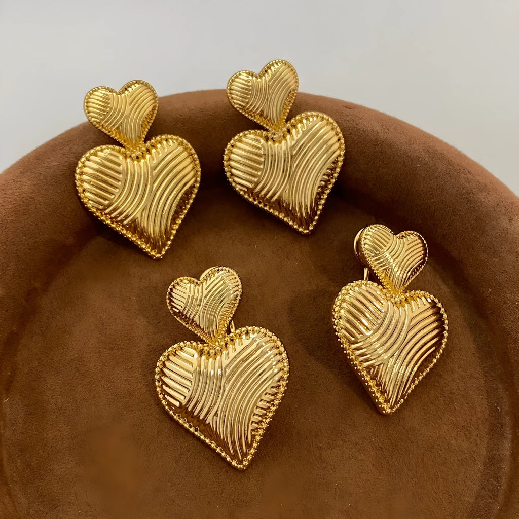 Double heart copper earrings with electroplated finish, available as ear clips or ear studs