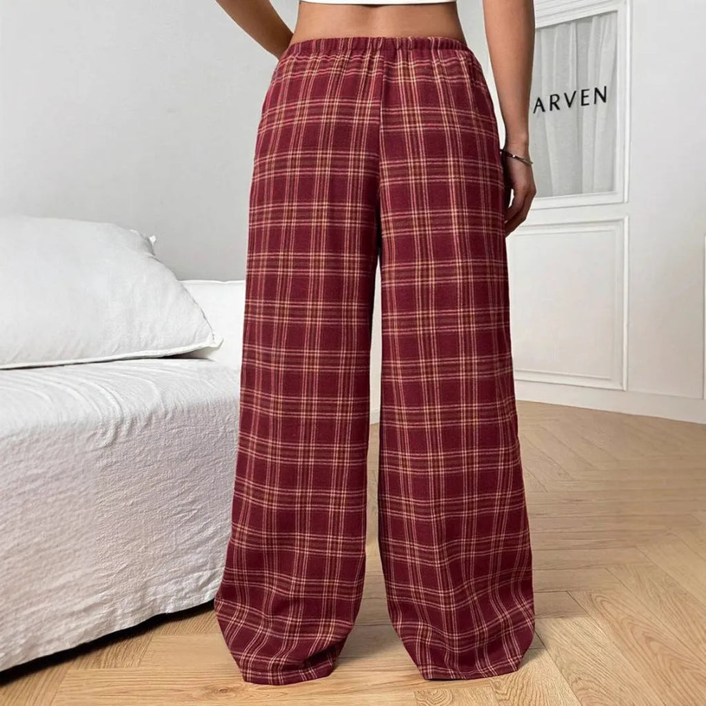 Women's red plaid casual trousers with drawstring waist and side pockets laid flat