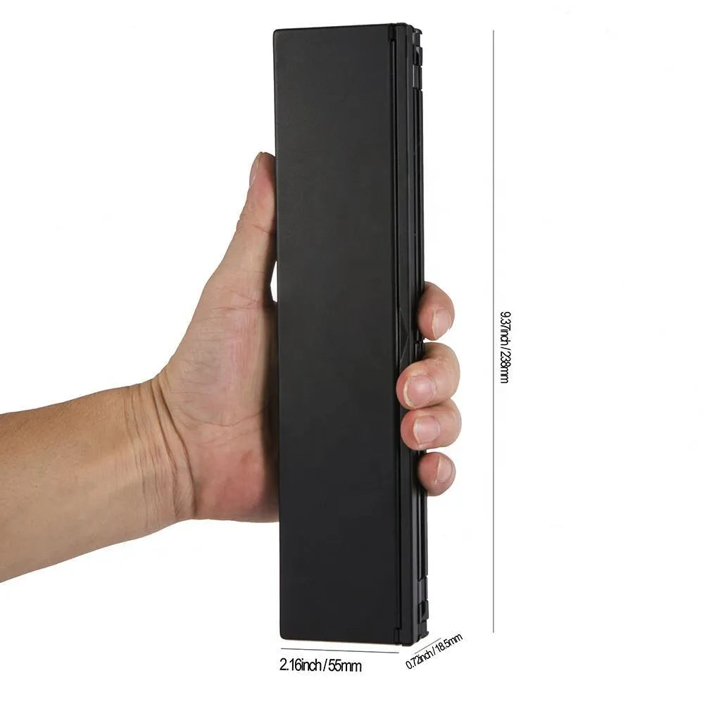 Mini folding ultra-thin wireless Bluetooth keyboard in black, open and ready for typing with a tablet