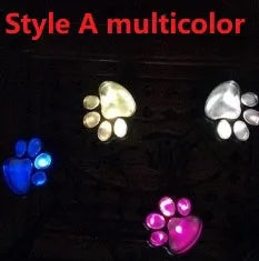 Four black bear paw-shaped solar garden lights connected to central solar panel pole
