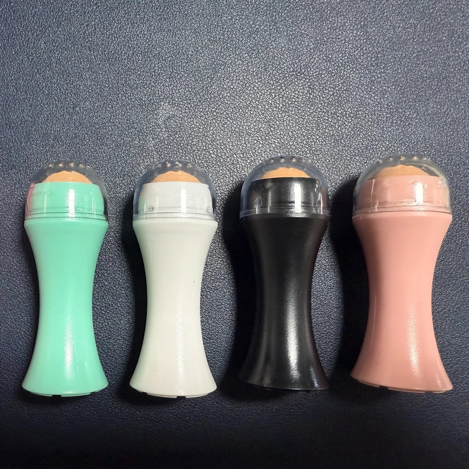 Volcanic portable roller for oily skin control in black, green, pink or white colours
