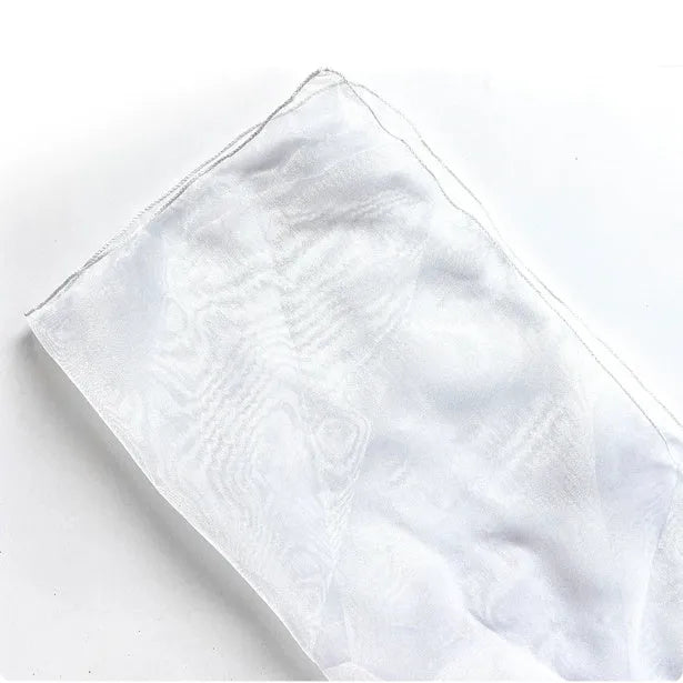 Silk bouquet wrap fabric 60x60cm in grey, folded on a table with white flowers