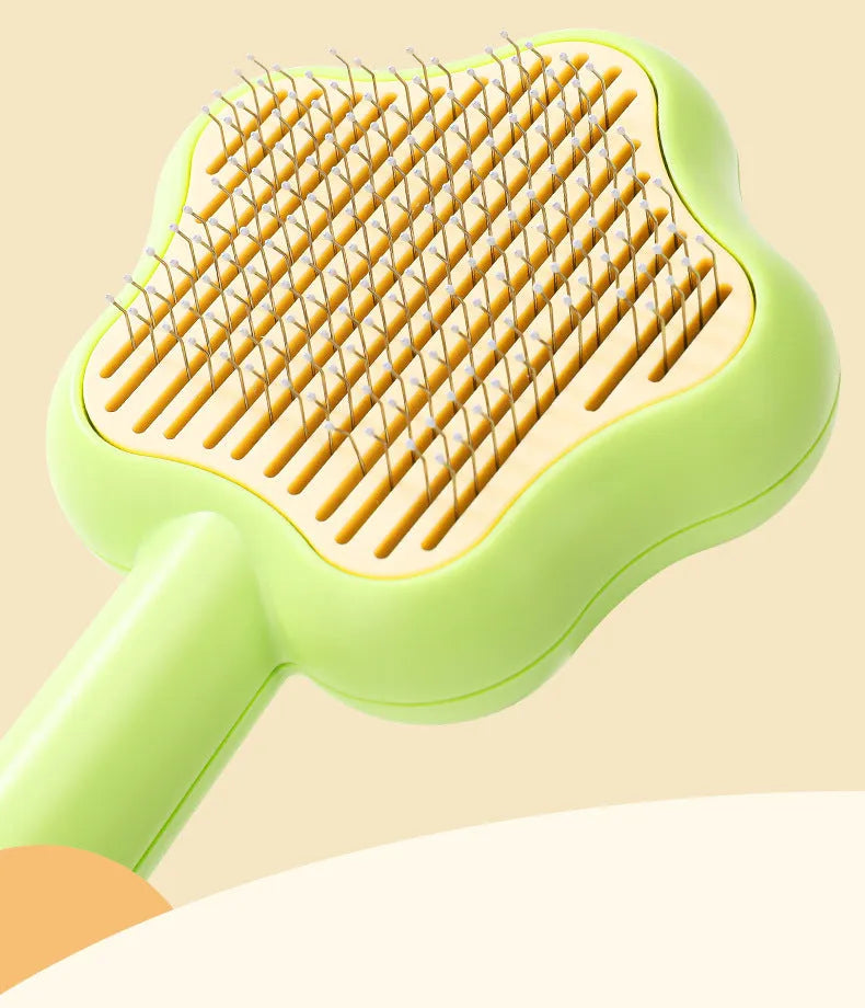Green cat comb with stainless steel needles and self-cleaning magic wand function on white background