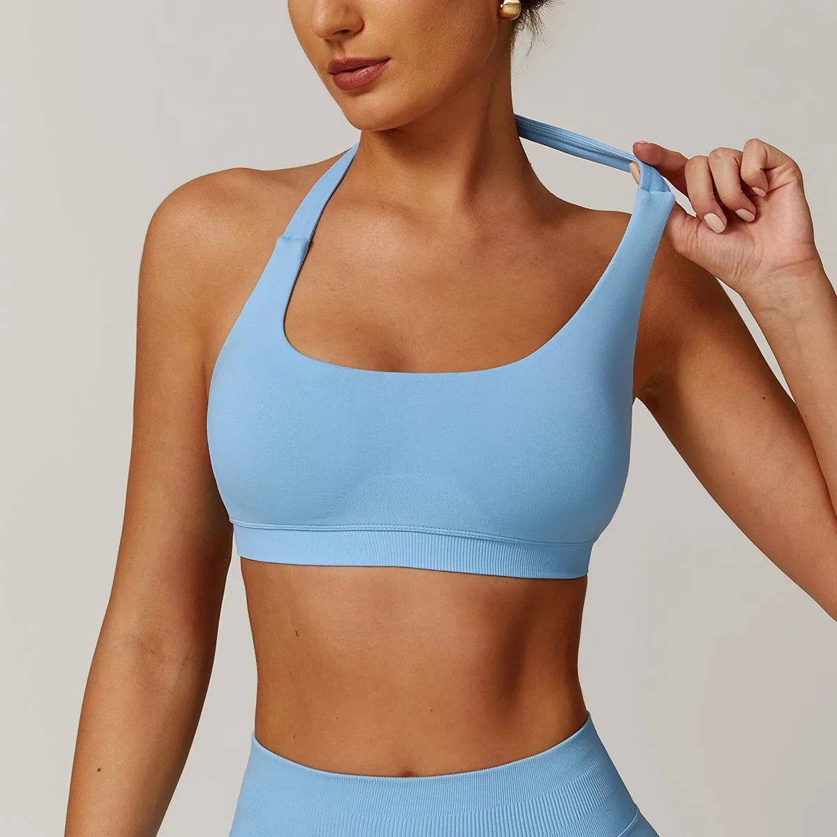 Women's halter neck sports bra in plum purple colour on a mannequin