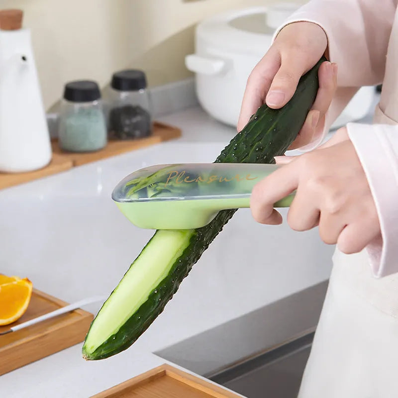Dark green kitchen peeler with storage tube and stainless steel blade for fruits and vegetables