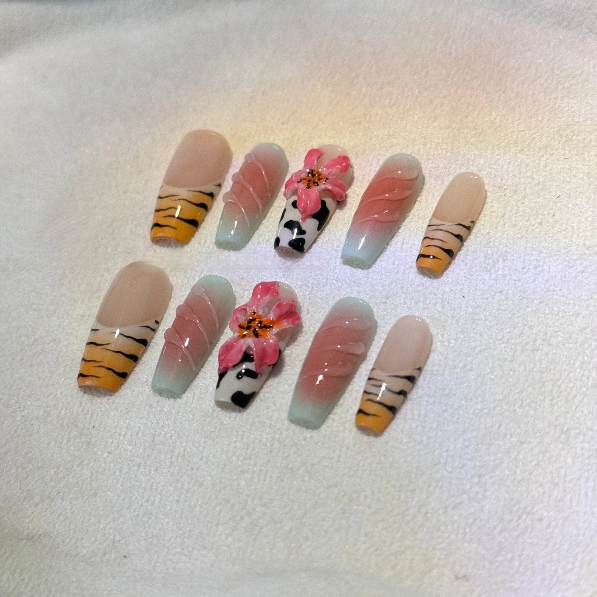 Lily hand carving acrylic nail art set featuring black and white zebra stripes with raised pink floral embossments.