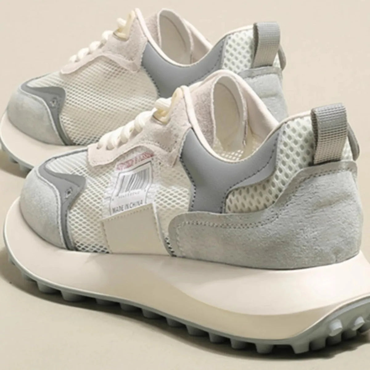 Women's grey and pink retro sneakers with low-top design and round toe