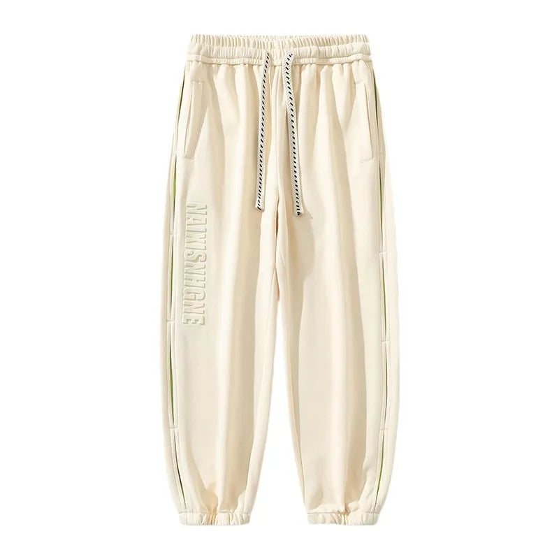 Men's loose-fit cotton trousers with printed stitching detail and ankle banding in grey green colour