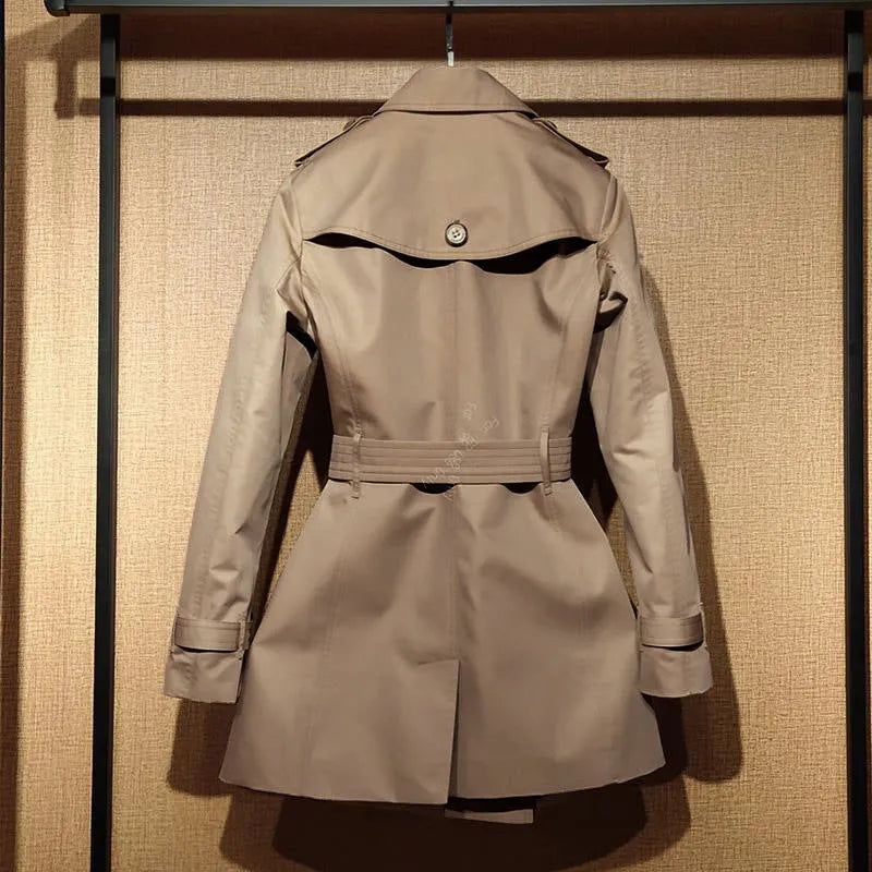 Khaki double-breasted trench coat for women with flight sleeves and button fastening.