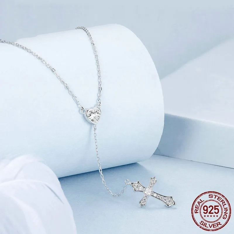 Simple sterling silver cross necklace with V-neck pendant on an O-ring chain.