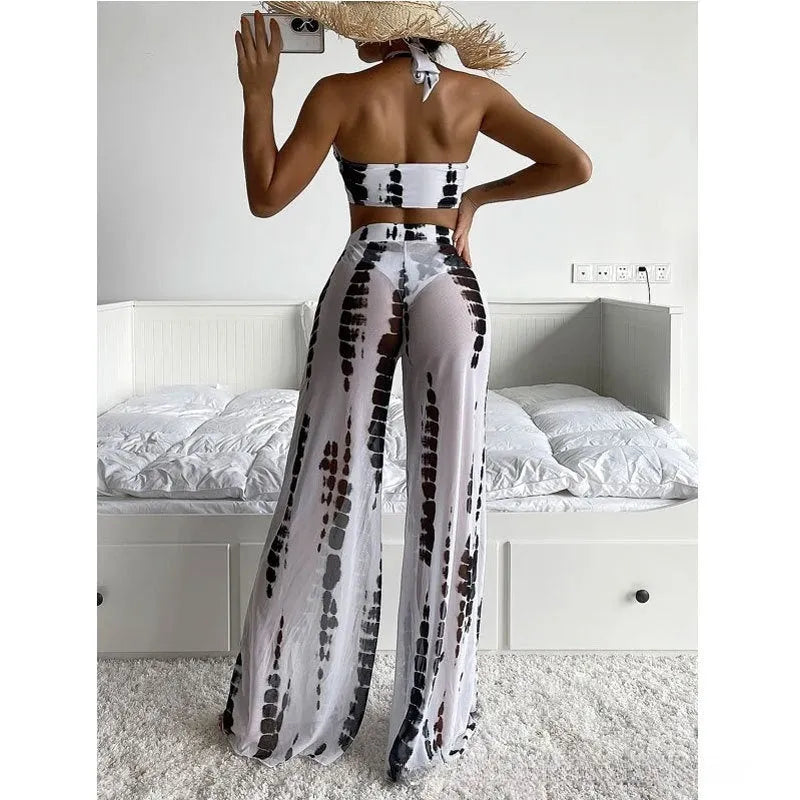 Women's three-piece printed swimsuit set with bikini top, pants, and mesh trousers.