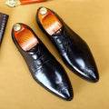 Men's pointed carved cowhide leather formal shoes in black with rubber sole and round toe
