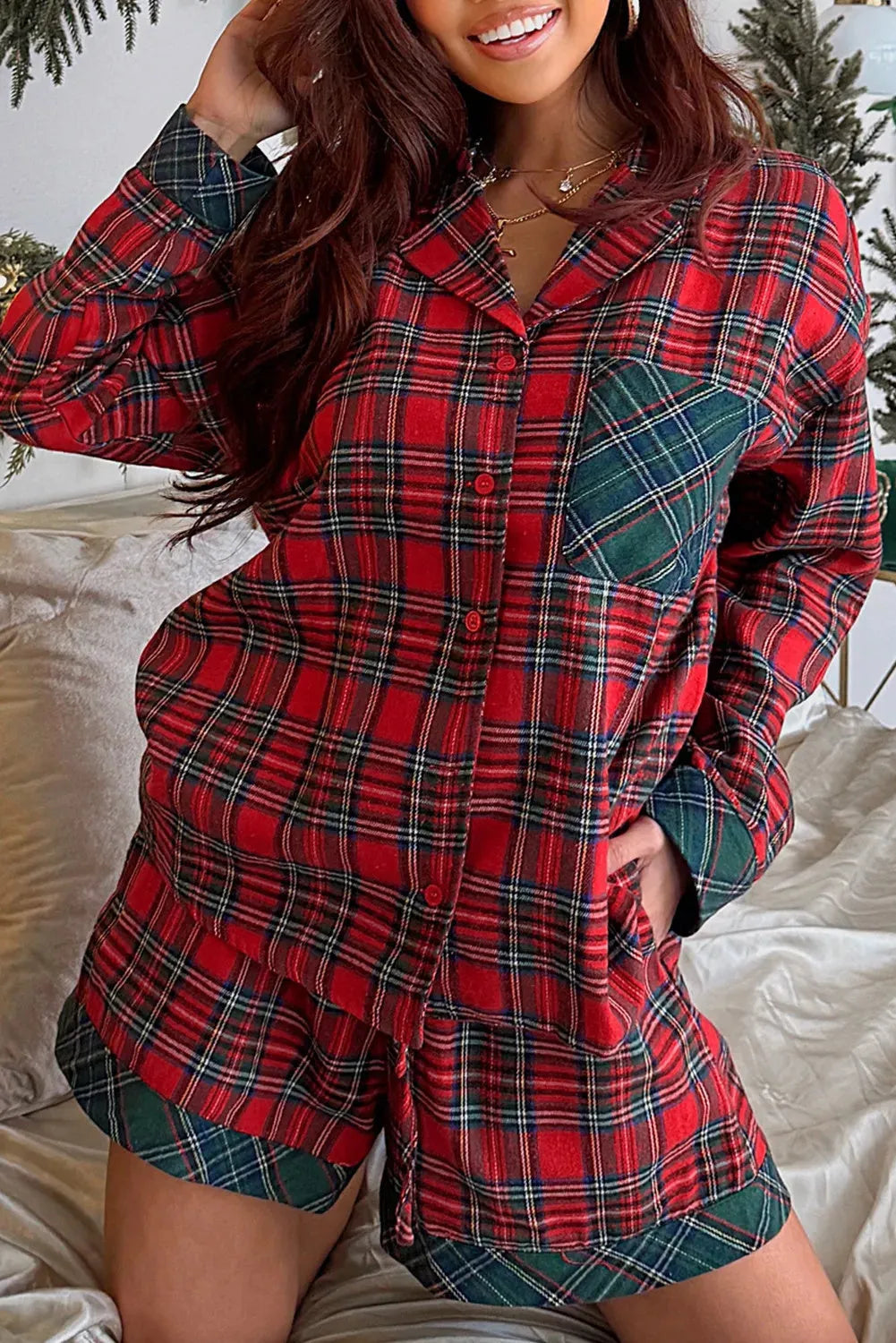 Red Christmas holiday pajama set with plaid patch detail on the long sleeve shirt and matching shorts.