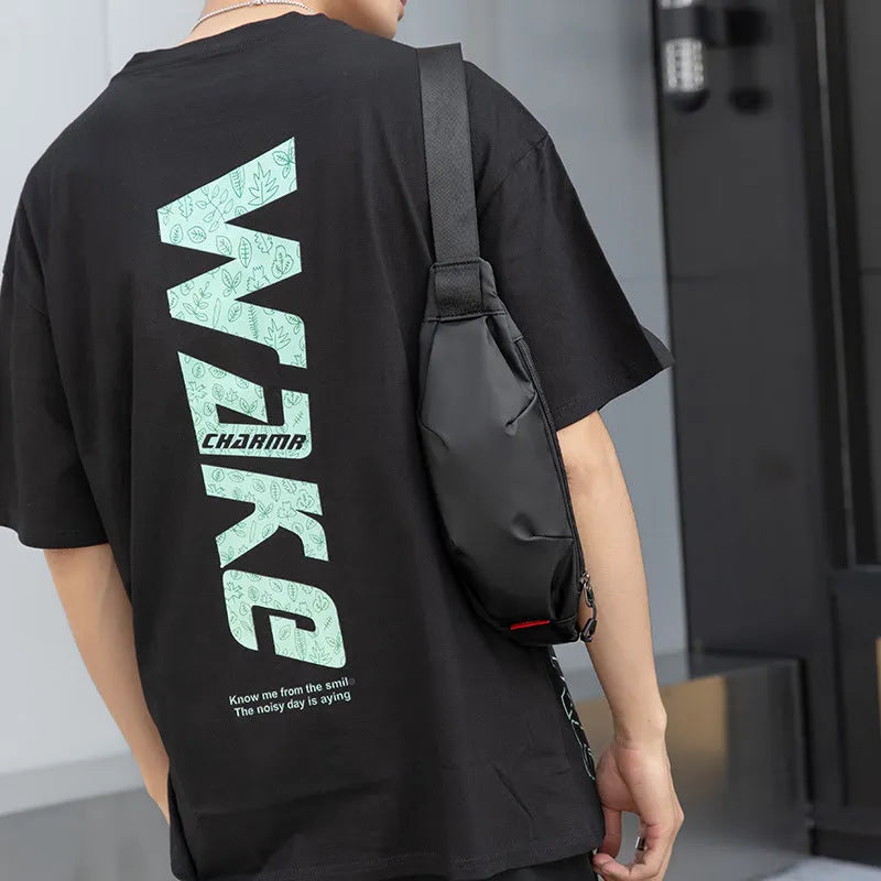Black Oxford cloth waist pack showing front zipper and compact rectangular shape.