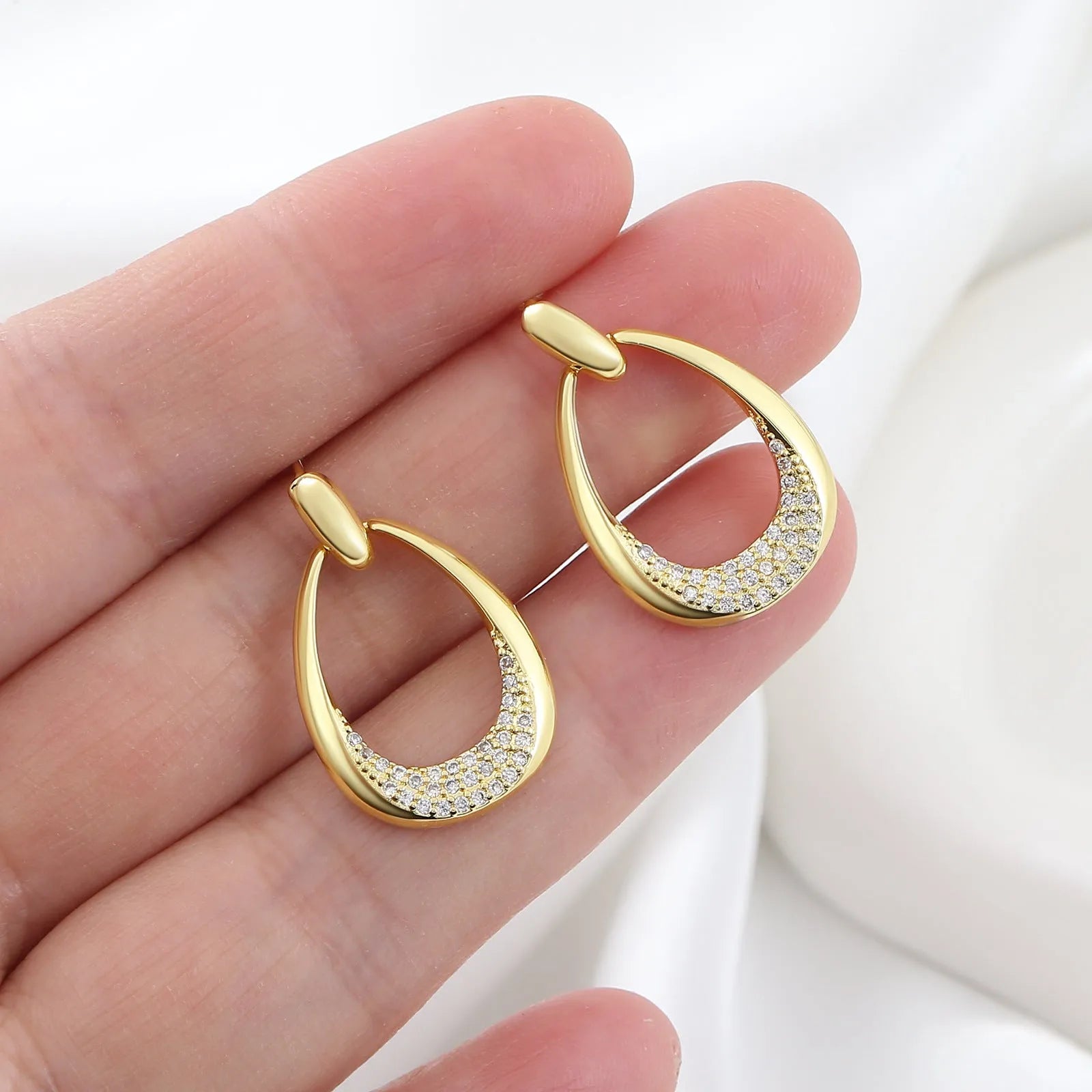 Yellow gold geometric drop earrings with zircon detailing measuring 2.6 by 1.7 centimetres