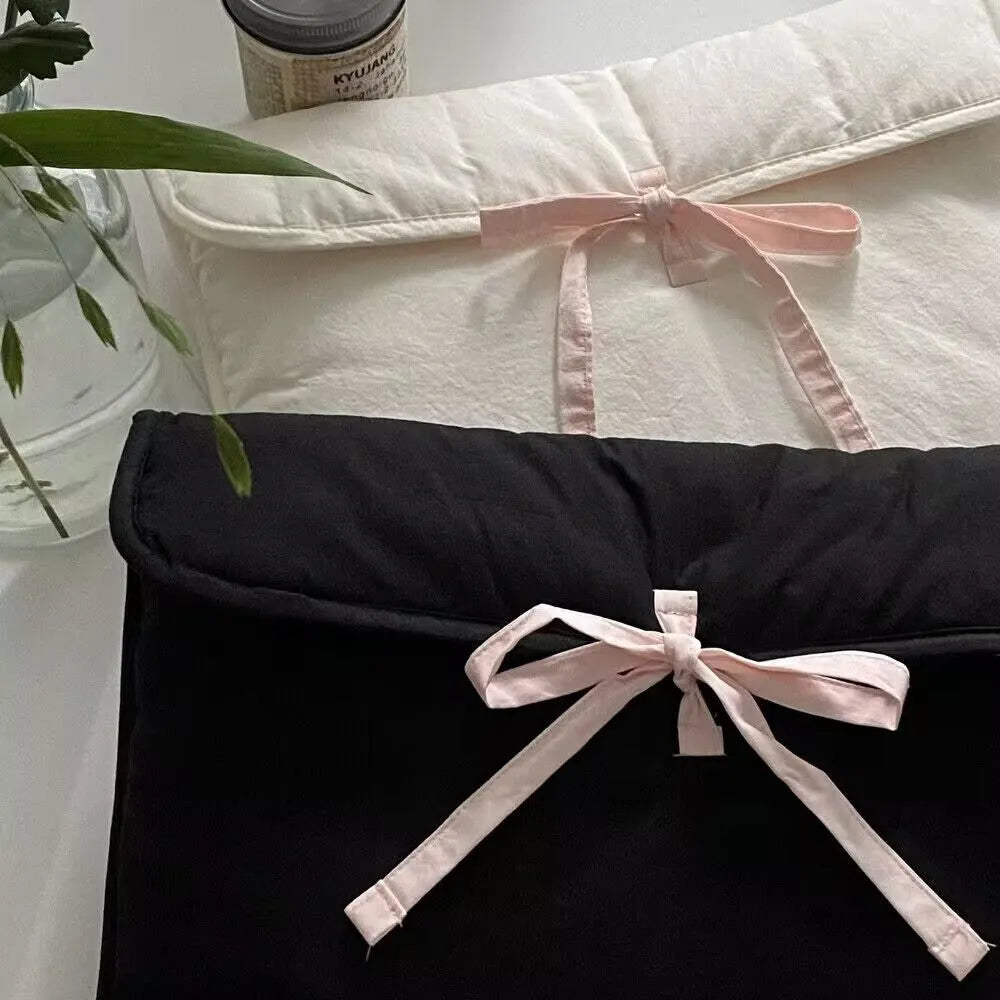 Women's black and white quilted laptop bag with decorative bow in two size options