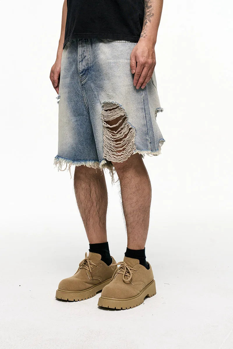 Light blue men's baggy denim shorts with a wide leg and retro washed finish on a mid-waist.