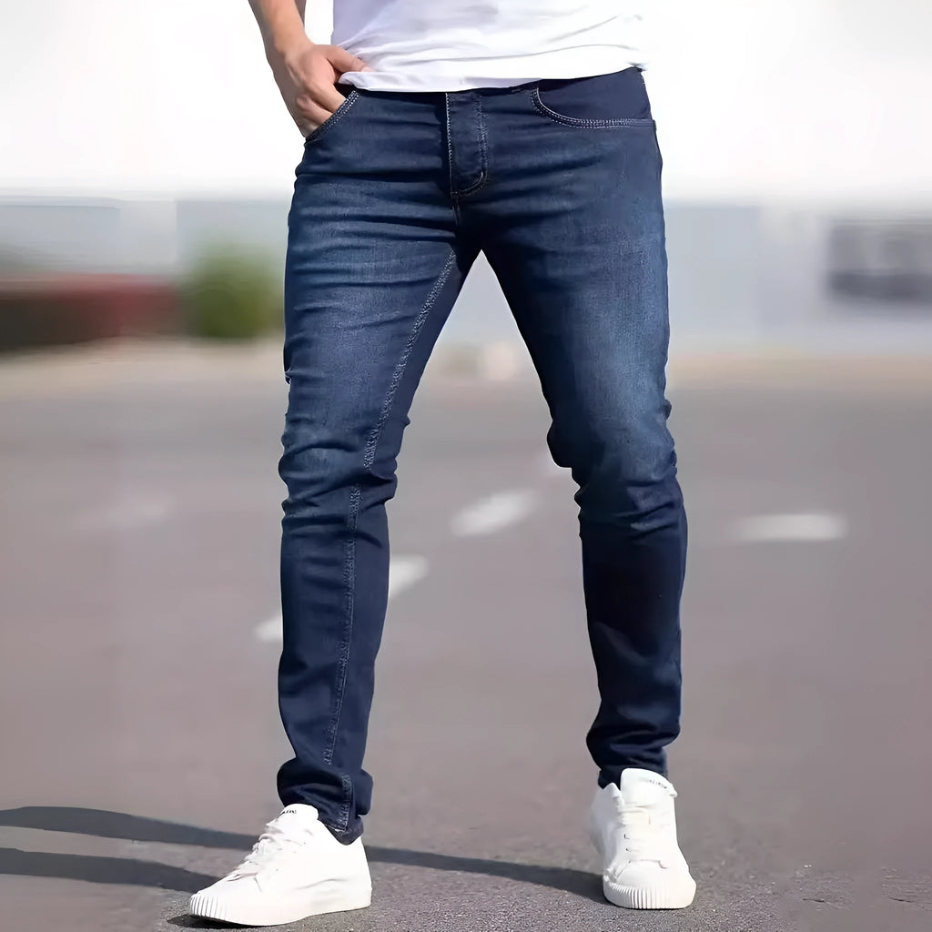 Dark blue men's slim fit cotton jeans with a skinny leg opening on a mannequin
