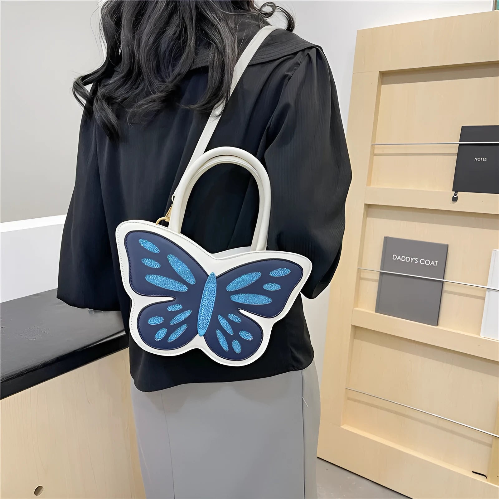 Women's square crossbody bag in PU leather showing black, blue, pink and white colour options with 27cm width