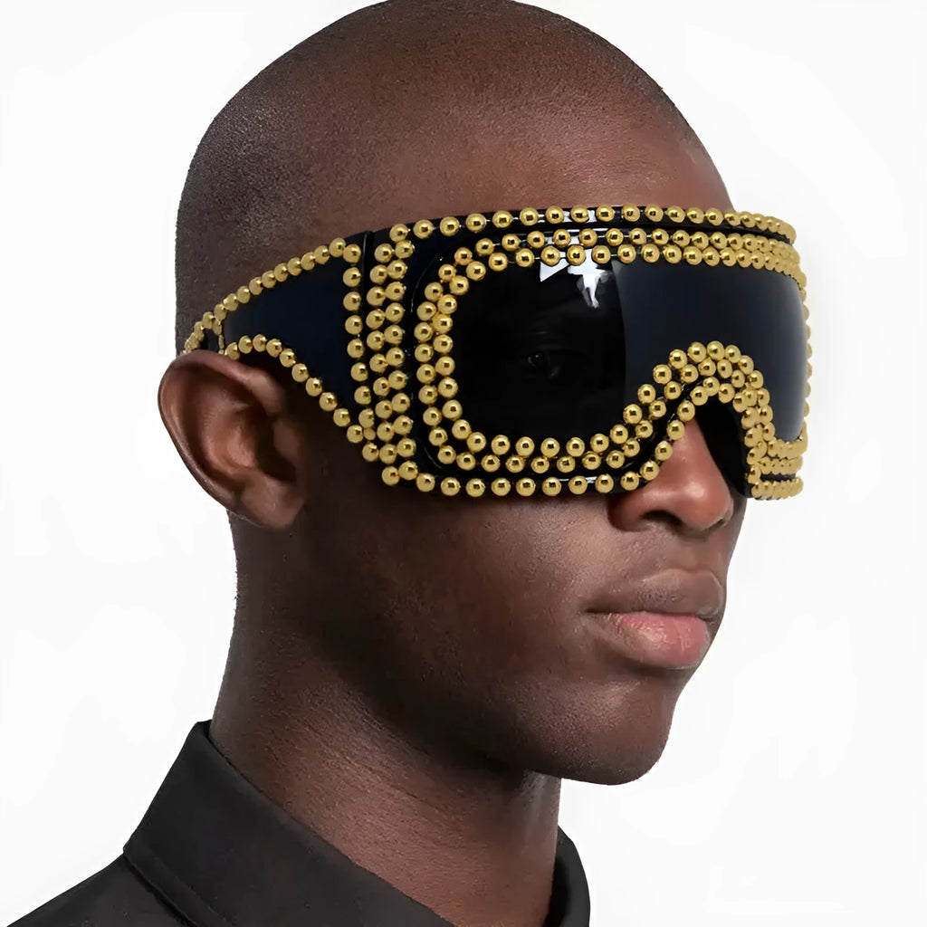 Punk sunglasses with large square frames and metal rivet details in gold colour
