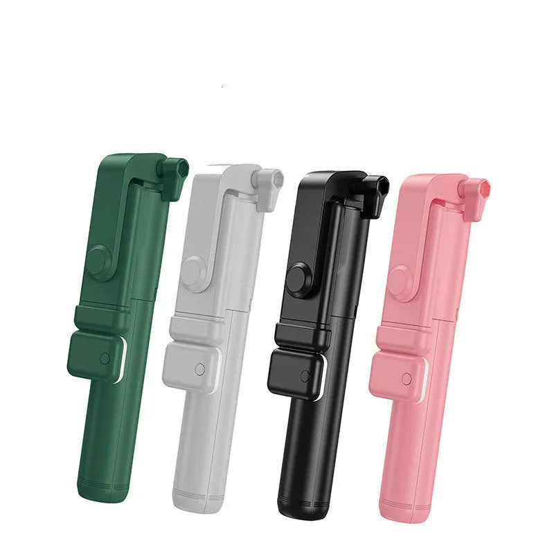 Black Bluetooth selfie stick with extended tripod legs and a fill light, holding an iPhone.