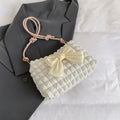 Women's horizontal square canvas handbag with single shoulder strap in black colour showing sandwich pocket detail