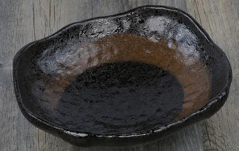 Japanese ceramic sashimi bowl with irregular shape and floral decorations