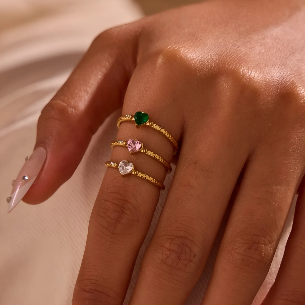 Open-ended heart-shaped ring with geometric design and zircon stones in stainless steel