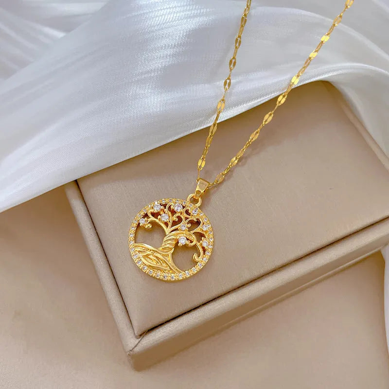 Gold-plated necklace with a detailed rhinestone lucky tree pendant on a Mother Pearl base.