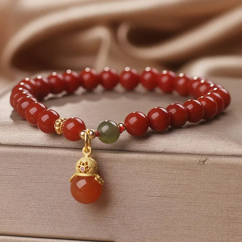 Natural red agate bracelet with zodiac pendant on wrist
