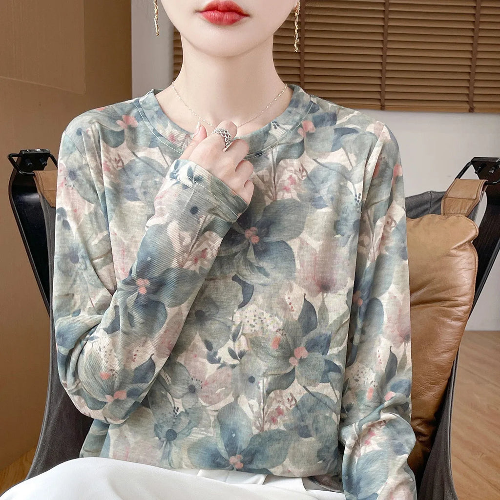 Women's round neck floral print pullover top in Tencel cotton fabric on a hanger.