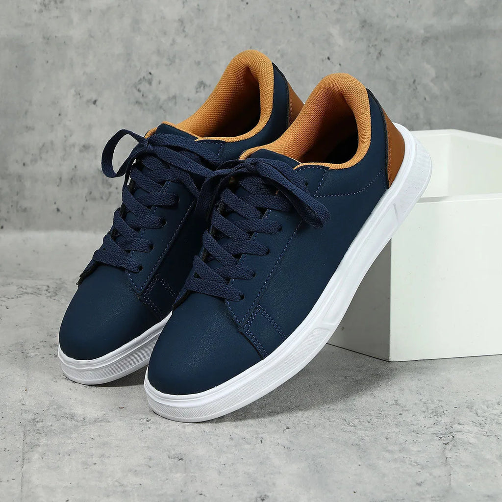 Beige brown platform casual sneaker with cross-belt detail and a low-top silhouette on a white background.