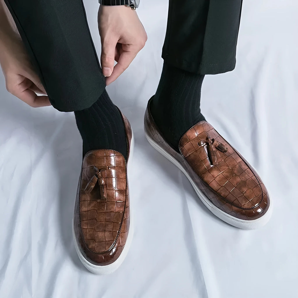Men's black plus size tassel sneakers with round toe and oversleeve closure on a rubber sole.
