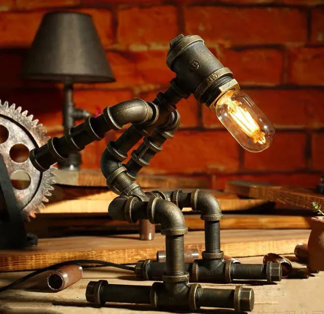 Green bronze industrial desk lamp with iron pipe design on wooden table
