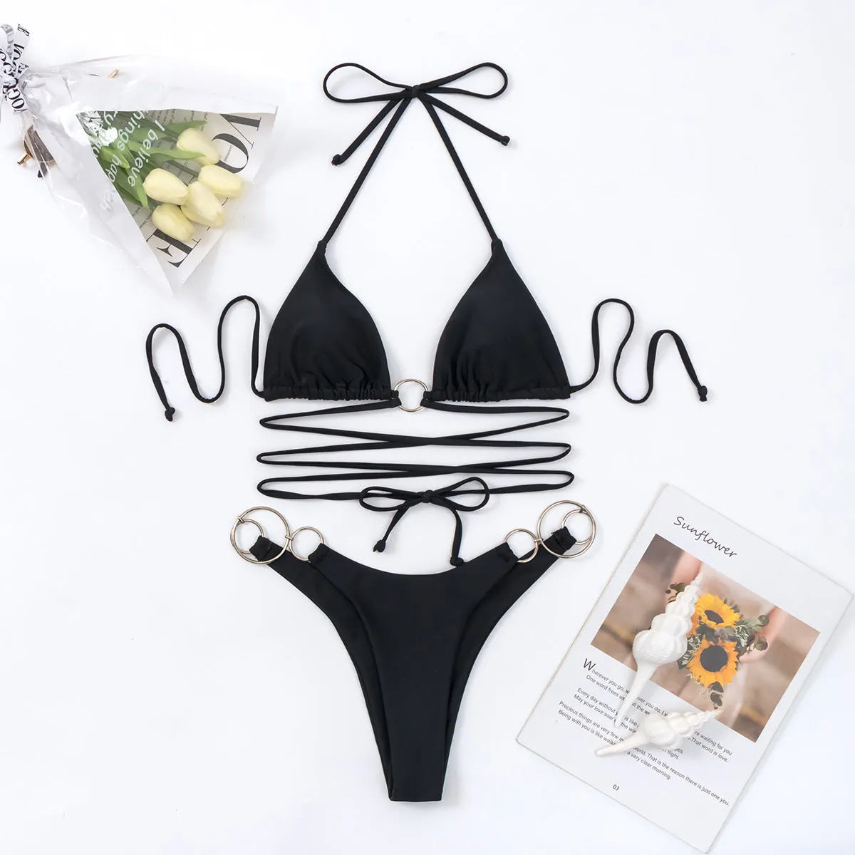 Women's black solid colour metal ring long strap split bikini swimsuit set on display, showing backless top and tie side bottom