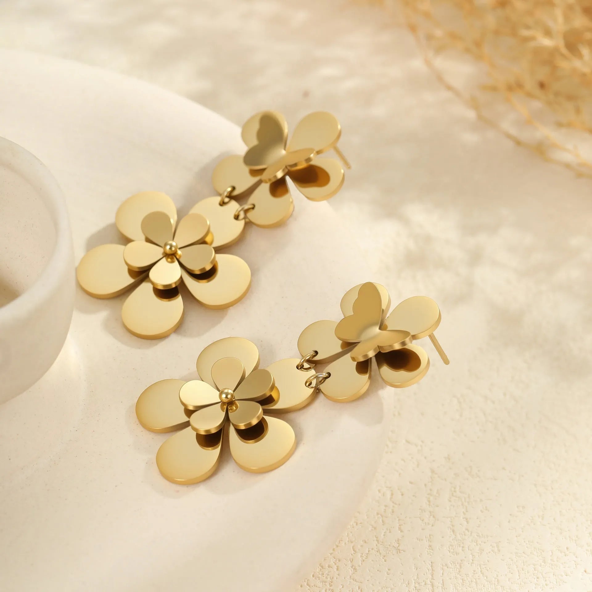 Women's stainless steel earrings with 18K gold electroplated flower butterfly design and post backs